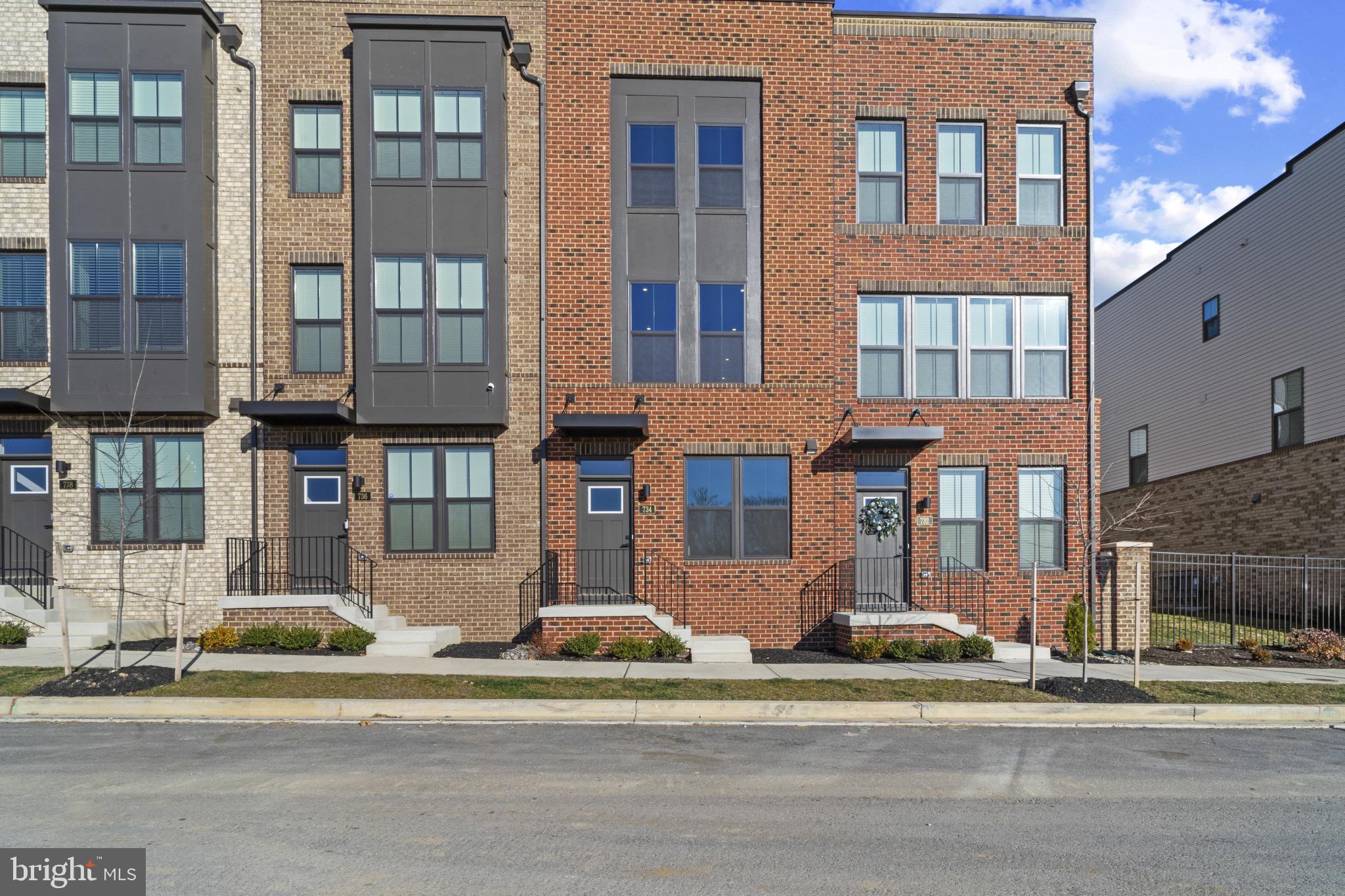 734 Watts Street Baltimore, MD 21217 - Photo 1 of 25 a front view of a residential apartment building with a yard