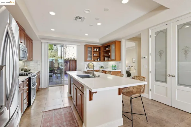 a large kitchen with a large counter top appliances and cabinets
