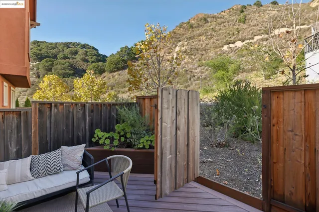 a view of a wooden bench in the backyard