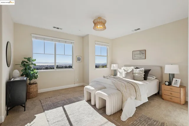 a bedroom with a bed and a potted plant