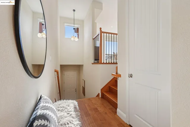 a view of a hallway with wooden floor and staircase