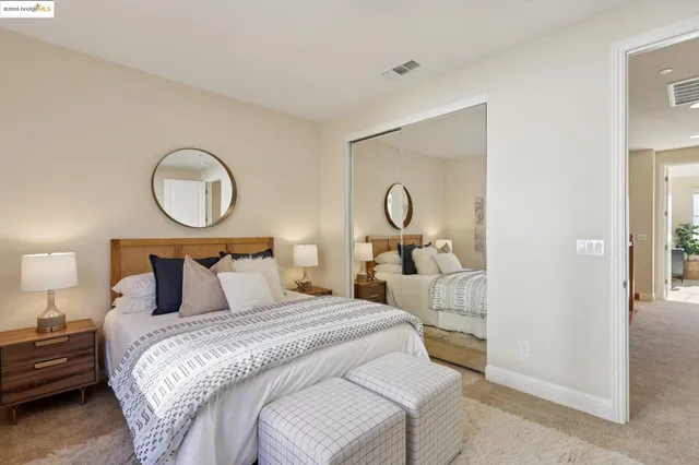 a bedroom with bed and a chandelier