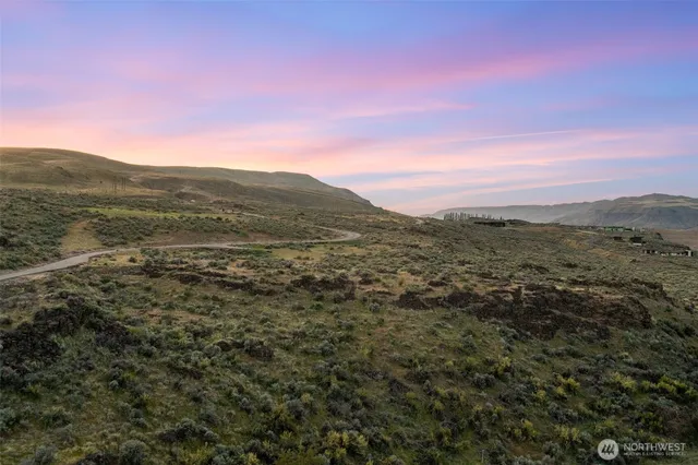 a view of a large mountain with mountains in the background