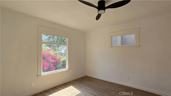 a view of a room with window and hardwood floor