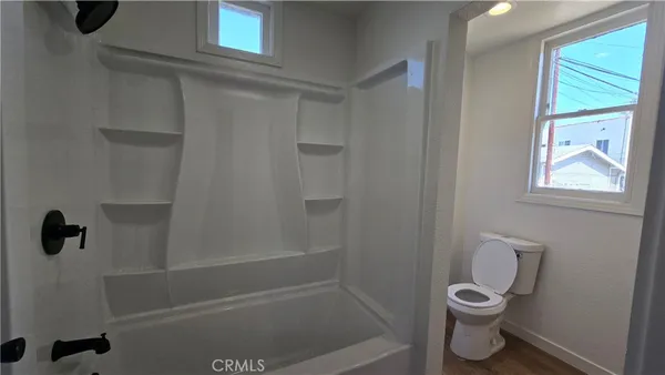 a bathroom with a toilet and a shower
