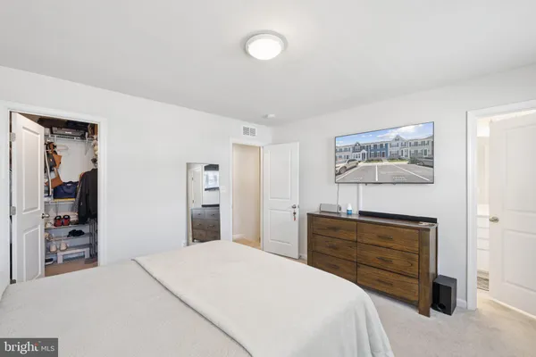 a bedroom with a bed and a dresser