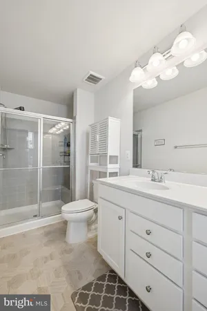 a bathroom with a double vanity sink toilet and shower