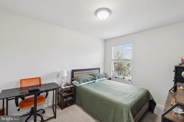 a bedroom with a bed and two windows