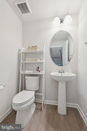 a white toilet sitting next to a bathroom sink