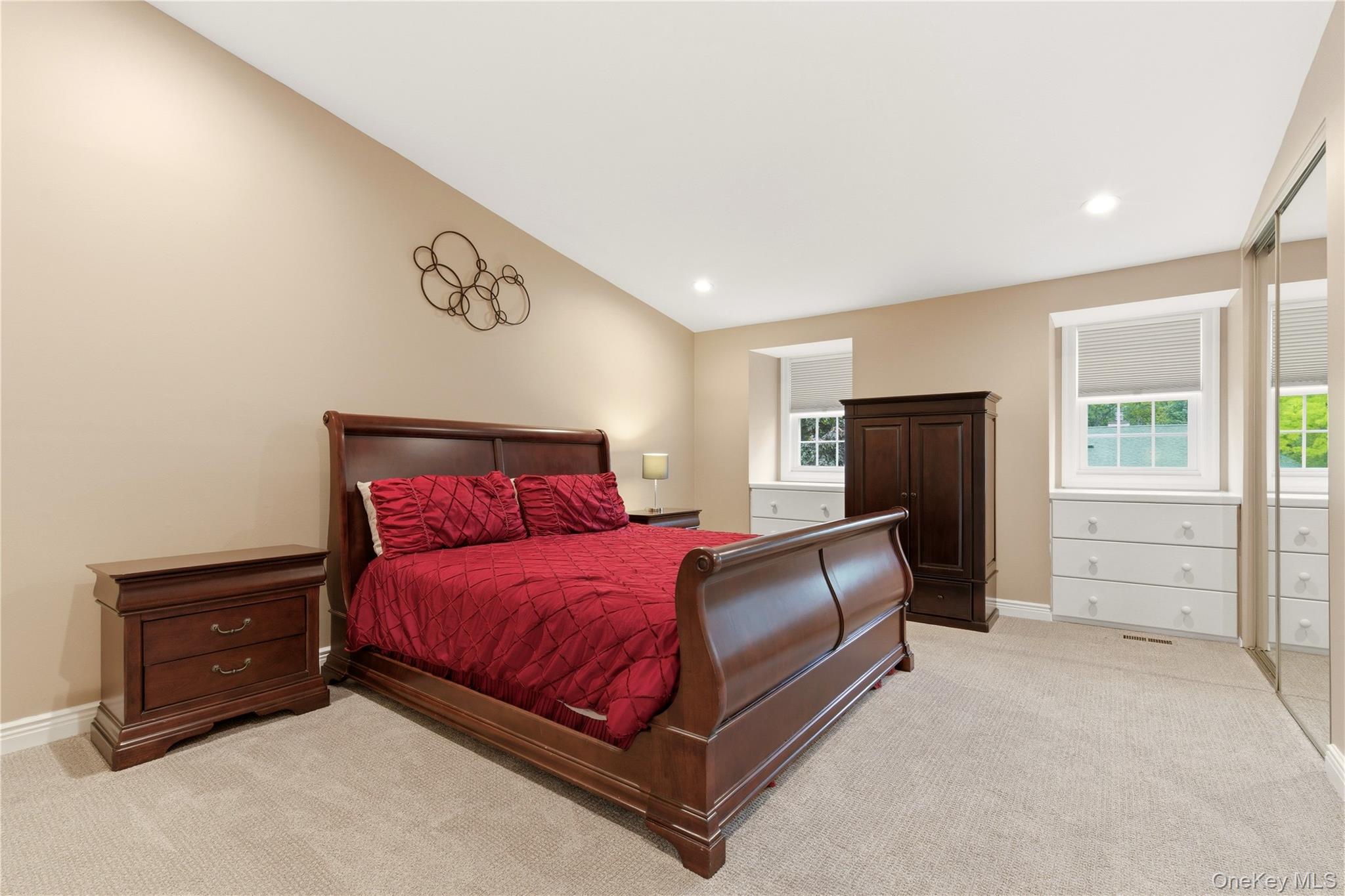 44 Hidden Ridge Drive Syosset, NY 11791 - Photo 11 of 28 a bedroom with a bed and a flat tv screen on the dresser