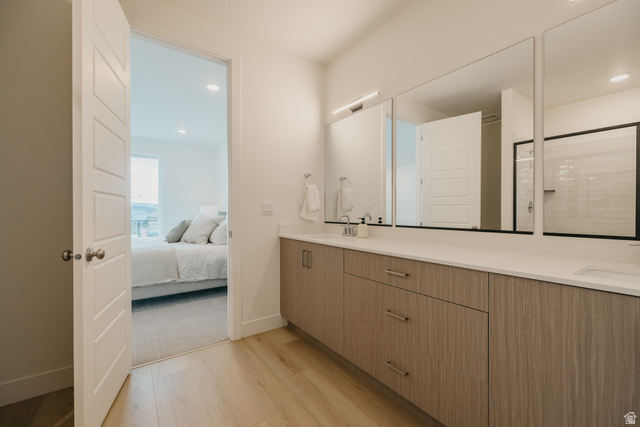 2759 Becco Trail, Unit 16 St. George, UT 84770 - Photo 22 of 42 Bathroom with double vanity, light wood finished floors, connected bathroom, a shower with door, and recessed lighting