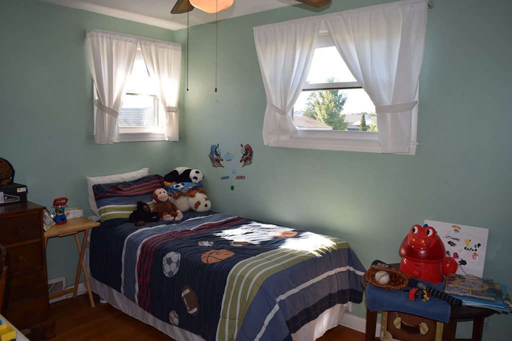 32 Rita Street Springfield, MA 01118 - Photo 14 of 29 a bed sitting in a bedroom next to a window