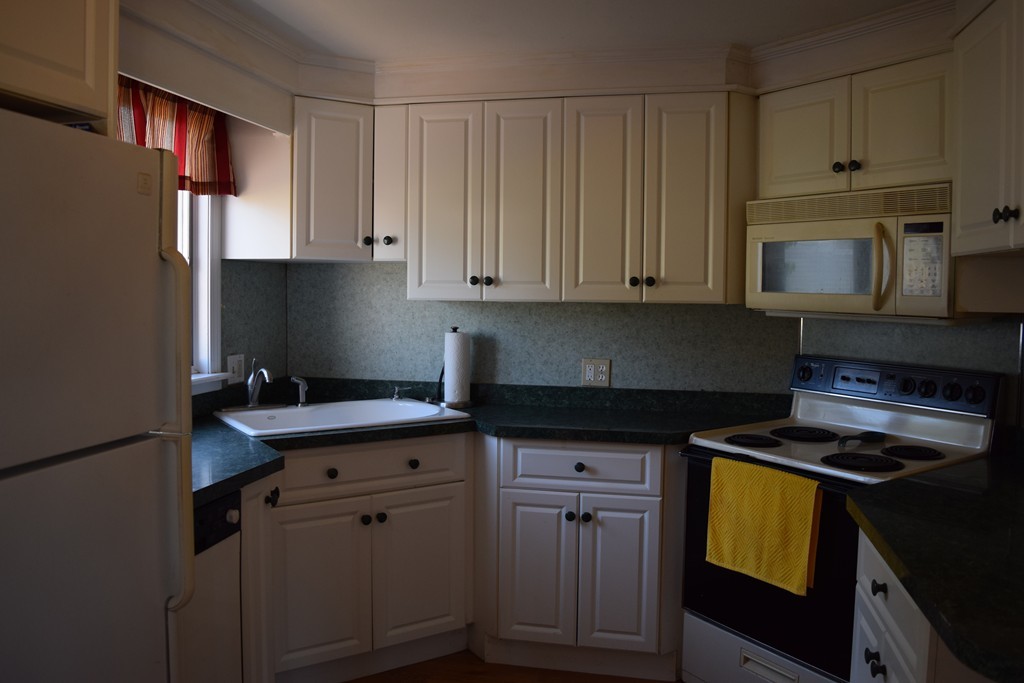32 Rita Street Springfield, MA 01118 - Photo 8 of 29 a kitchen with stainless steel appliances granite countertop a sink stove and cabinets