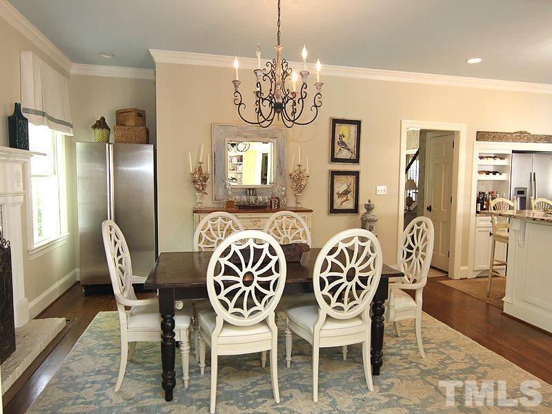 2305 Tyson Street Raleigh, NC 27612 - Photo 11 of 25 a view of a dining room with furniture a chandelier and wooden floor