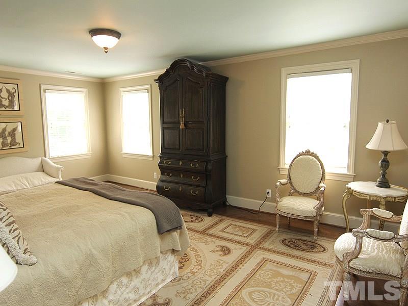 2305 Tyson Street Raleigh, NC 27612 - Photo 14 of 25 a bedroom with a bed chair and a large window