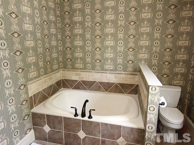 2305 Tyson Street Raleigh, NC 27612 - Photo 16 of 25 a bathroom with a toilet and a shower curtain