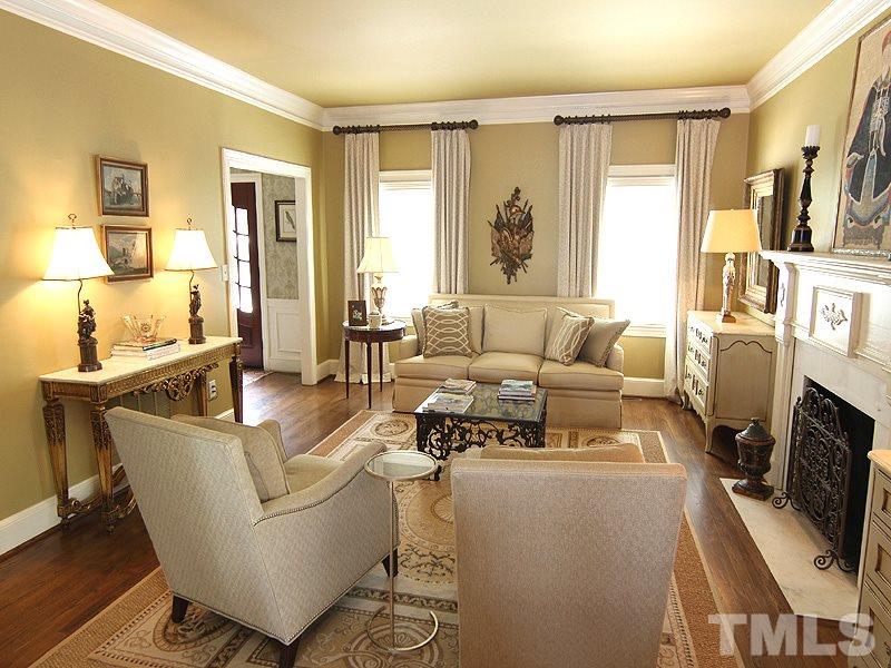 2305 Tyson Street Raleigh, NC 27612 - Photo 5 of 25 a living room with furniture and a fireplace