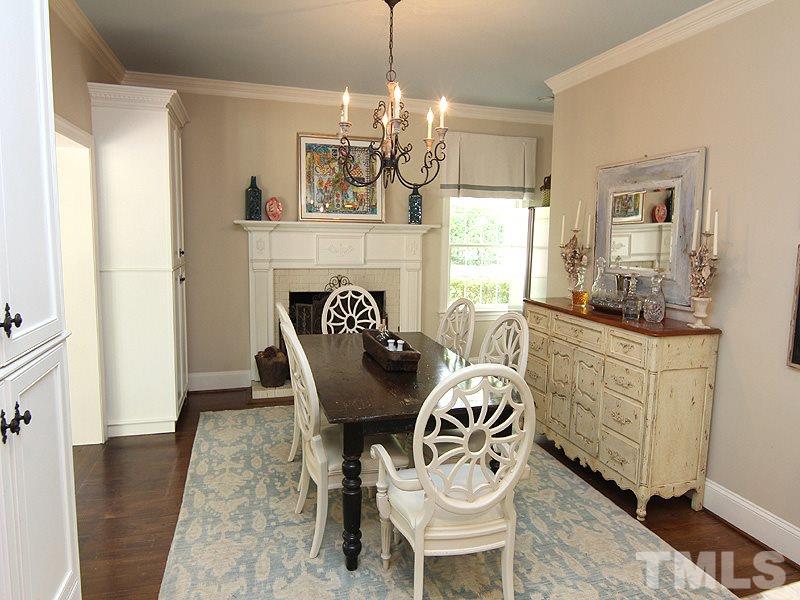 2305 Tyson Street Raleigh, NC 27612 - Photo 10 of 25 a dining room with furniture a chandelier and wooden floor