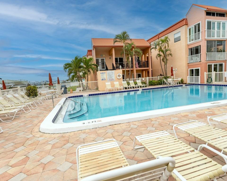 8911 Blind Pass Road, Unit 220 St. Pete Beach, FL 33706 - Photo 11 of 67 swimming pool view with a outdoor seating