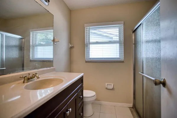 a kitchen with stainless steel appliances granite countertop a table chairs sink refrigerator and cabinets