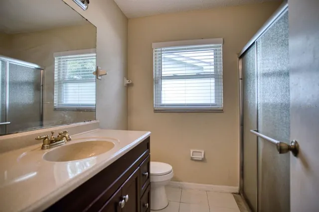 a kitchen with stainless steel appliances granite countertop a table chairs sink refrigerator and cabinets