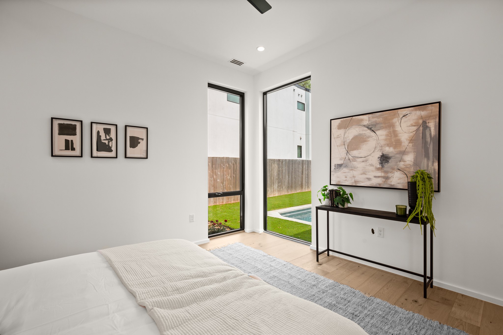 1805 Collier Street Austin, TX 78704 - Photo 15 of 39 Bedroom with light wood finished floors, ceiling fan, recessed lighting, and access to exterior