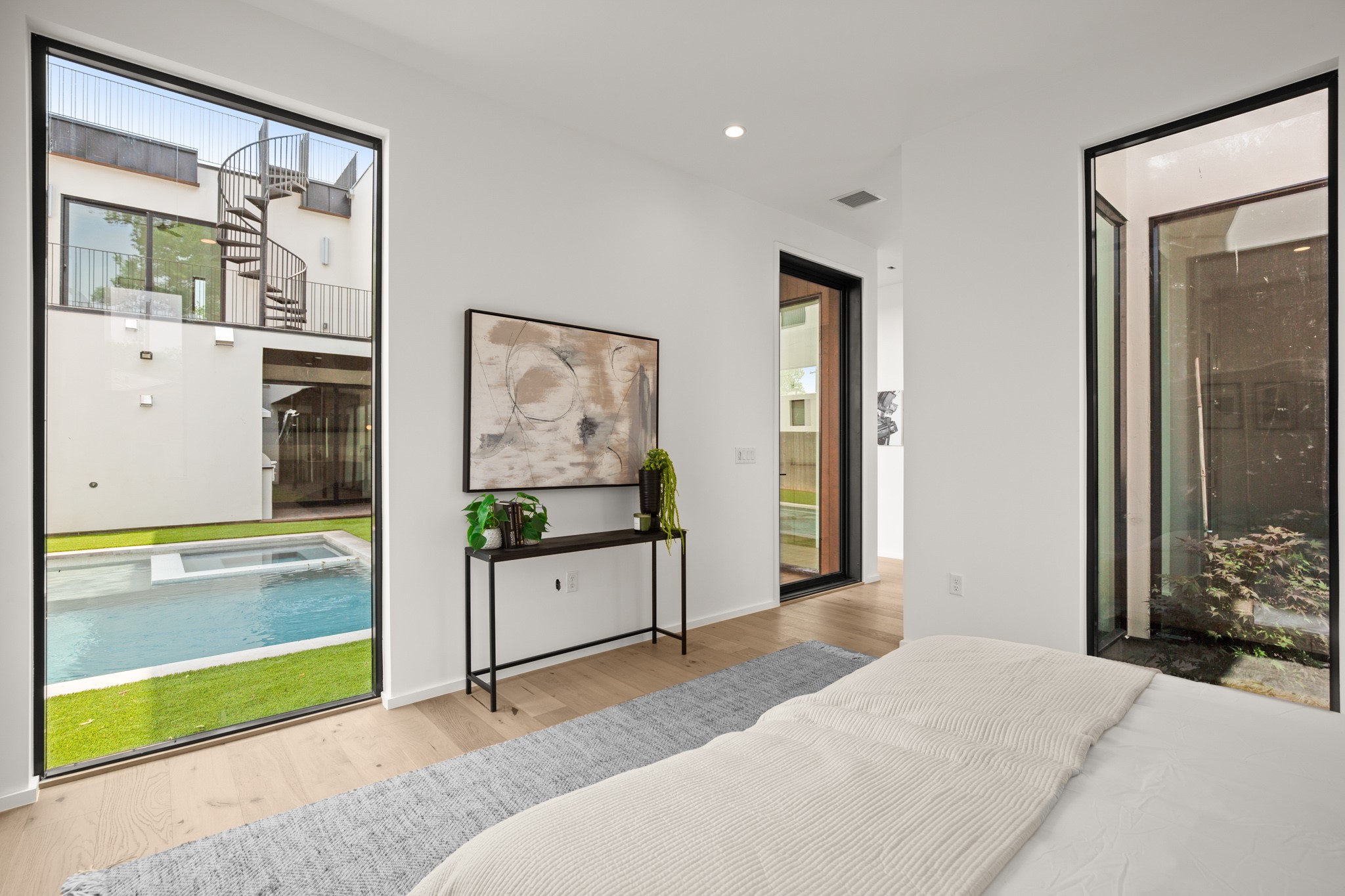 1805 Collier Street Austin, TX 78704 - Photo 16 of 39 Bedroom featuring access to exterior, light wood-style floors, recessed lighting, and connected bathroom