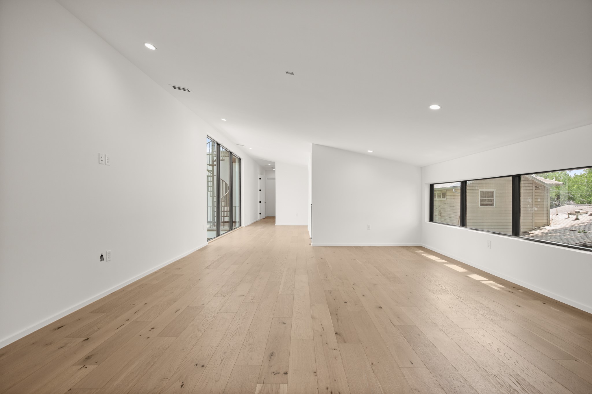 1805 Collier Street Austin, TX 78704 - Photo 23 of 39 Empty room with recessed lighting and light wood-type flooring