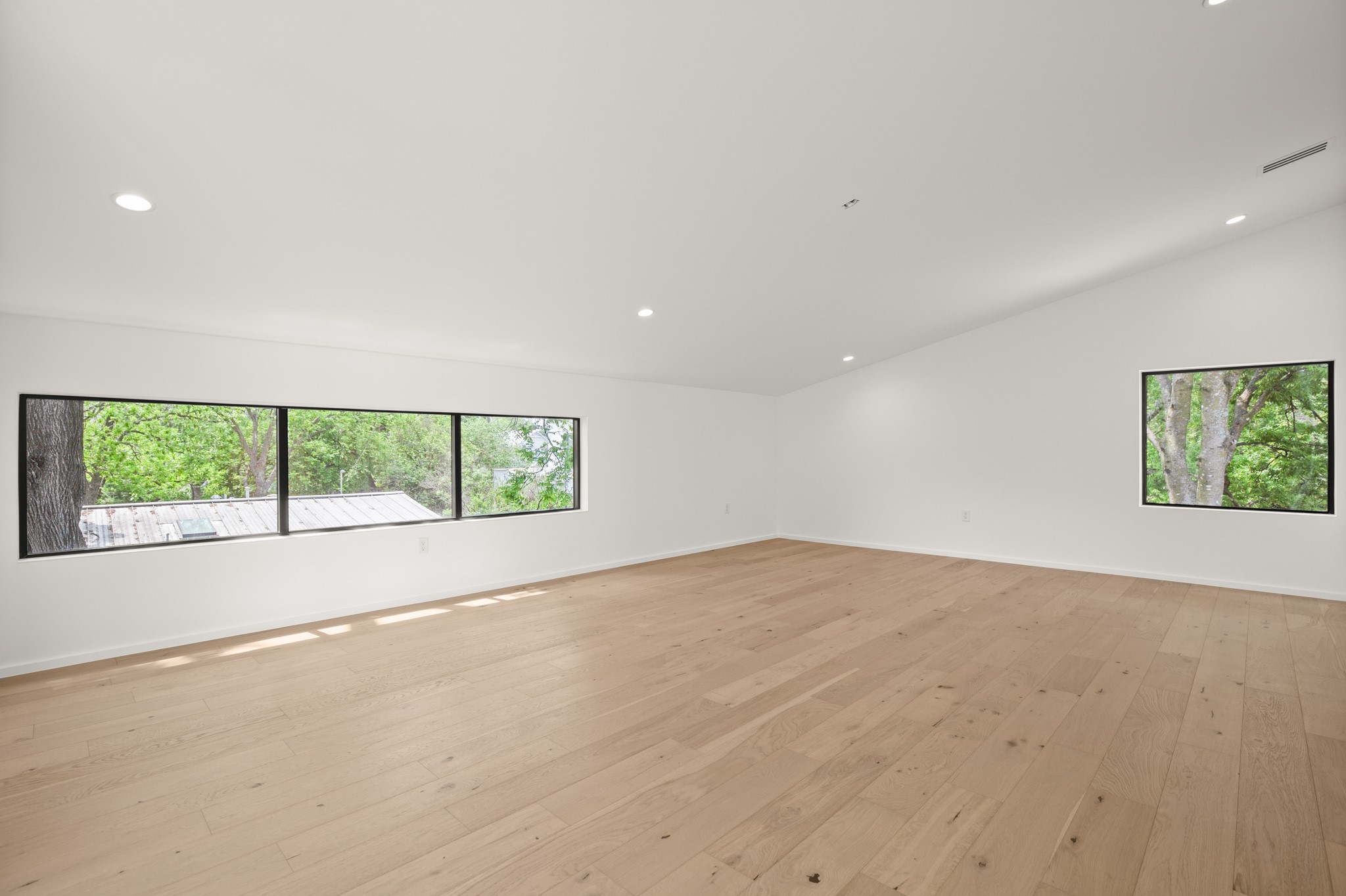 1805 Collier Street Austin, TX 78704 - Photo 24 of 39 Empty room with light wood-style flooring and recessed lighting