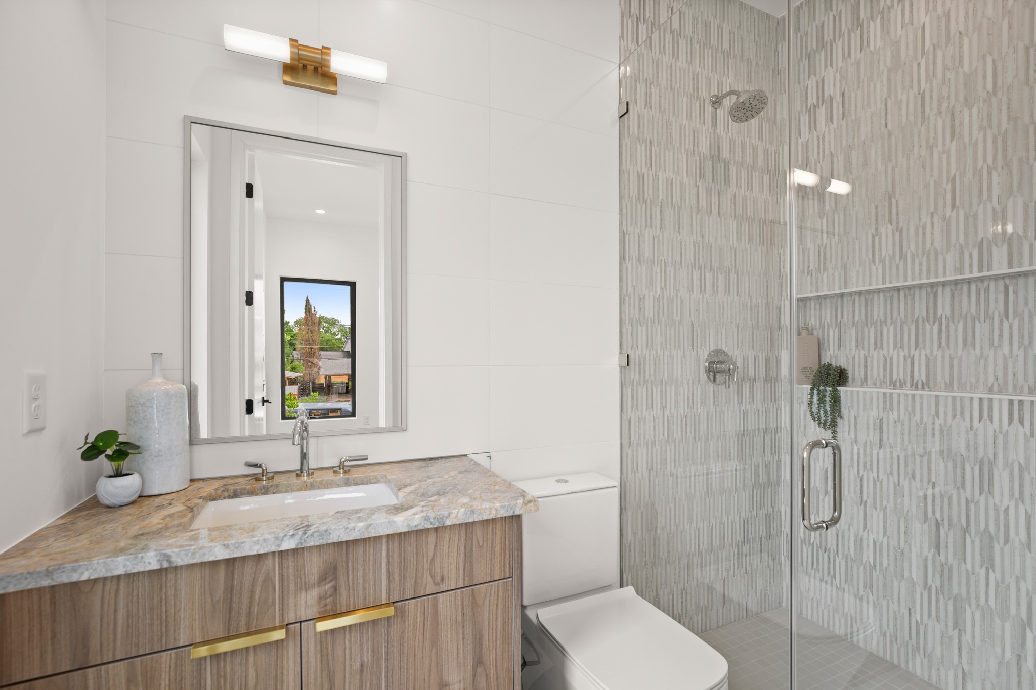 1805 Collier Street Austin, TX 78704 - Photo 31 of 39 Bathroom with vanity, a stall shower, and tile walls