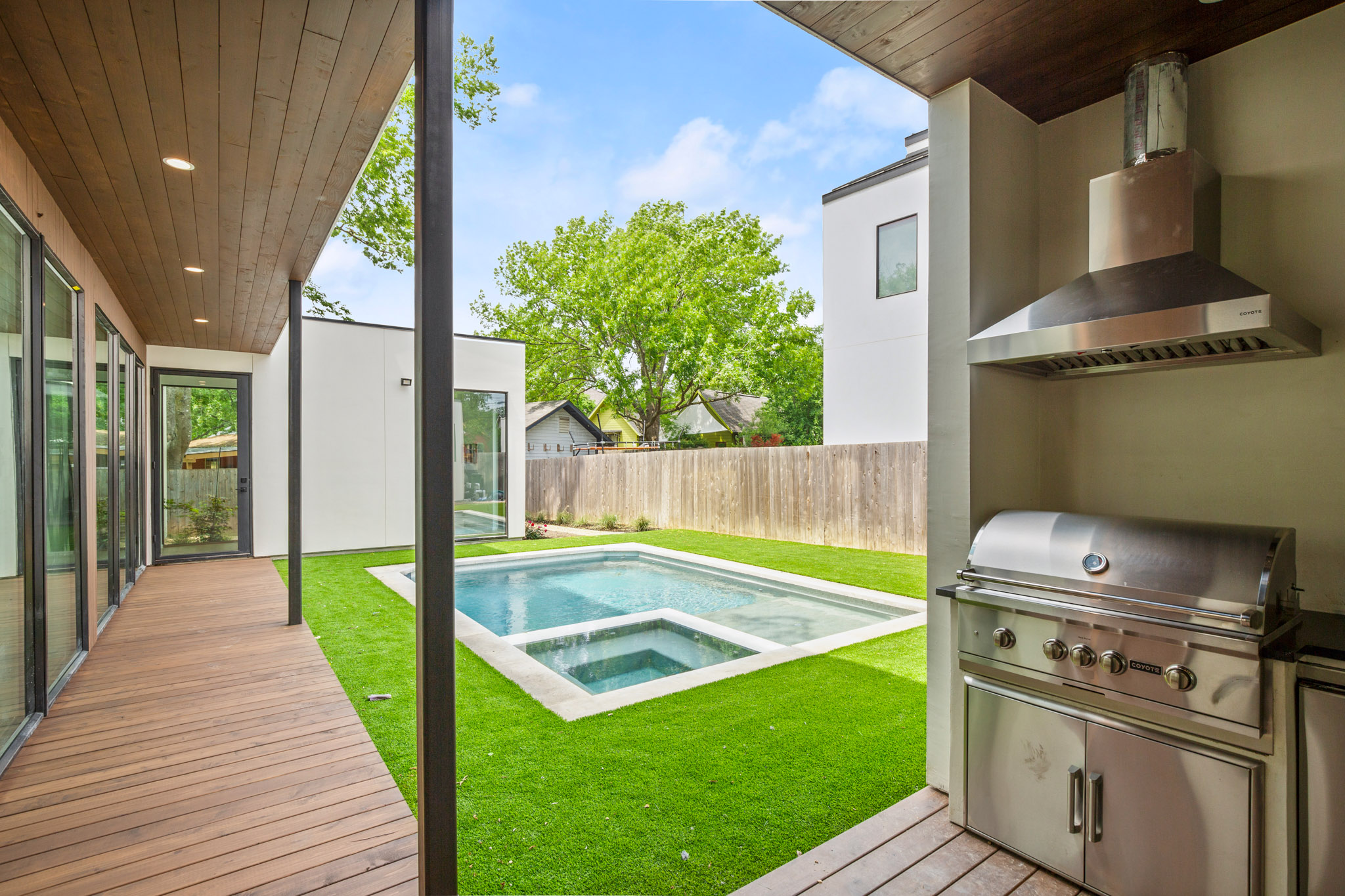 1805 Collier Street Austin, TX 78704 - Photo 35 of 39 Relaxing pool / spa featuring a patio, a fenced backyard, grilling area, and a wooden deck
