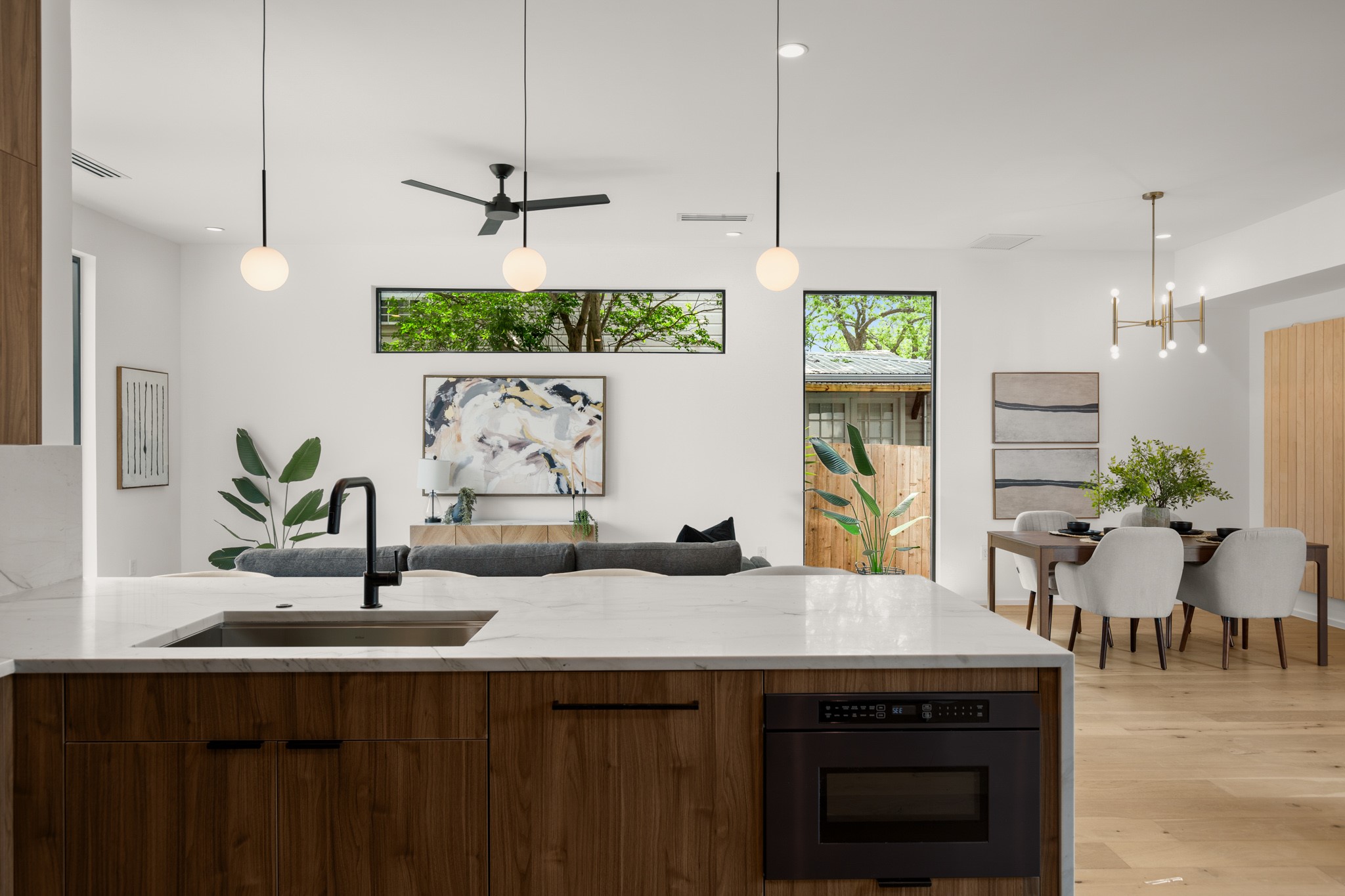 1805 Collier Street Austin, TX 78704 - Photo 7 of 39 Kitchen featuring light stone counters, a peninsula, modern cabinets, and black oven