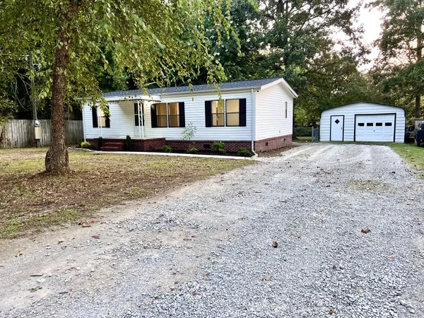 a view of a house with a yard and sitting area