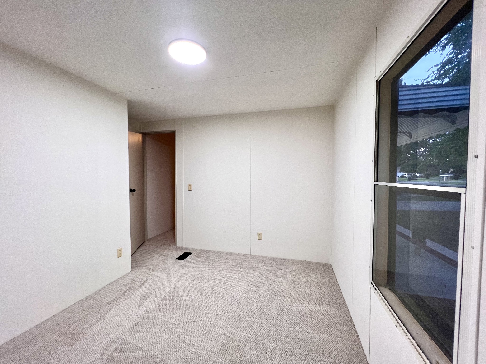 413 Elm Lane Beechgrove, TN 37018 - Photo 13 of 15 an empty room with sliding door and wooden floor