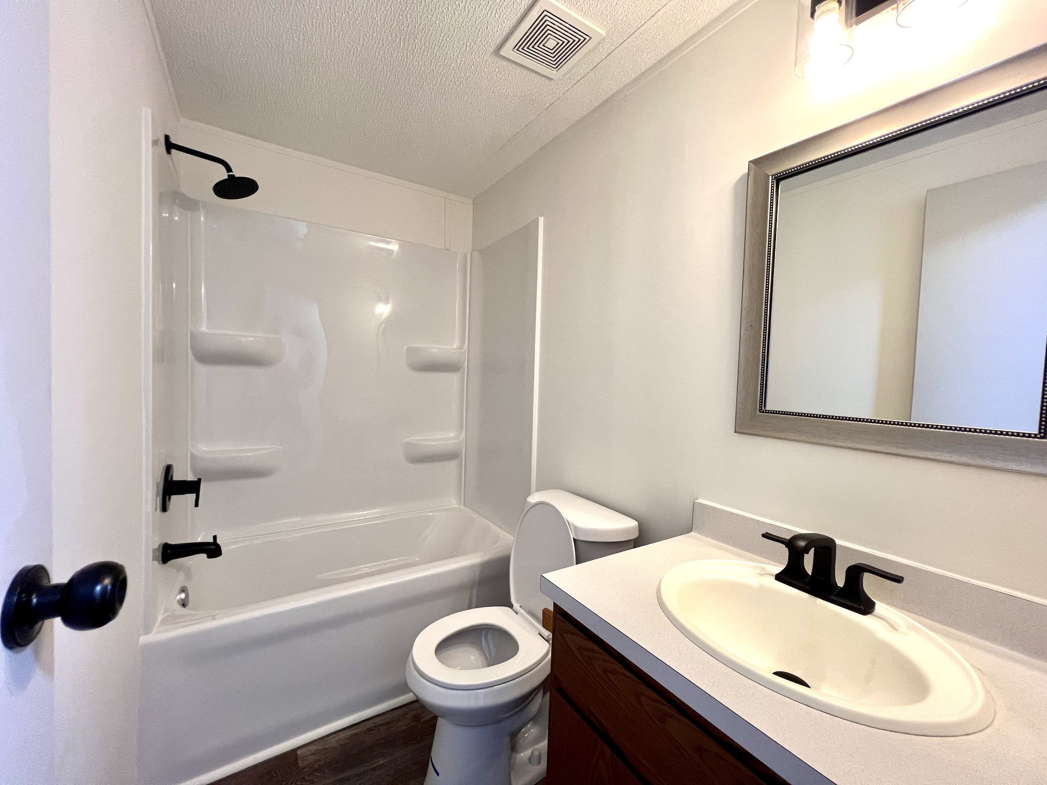 413 Elm Lane Beechgrove, TN 37018 - Photo 9 of 15 a bathroom with a sink a toilet a mirror and shower