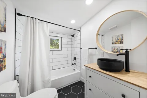 a bathroom with a toilet a sink and bathtub