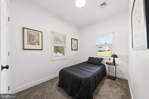 a living room with furniture a flat screen tv and potted plant