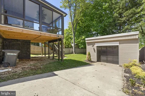 a backyard of a house with plants and tree