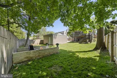front view of a house with a yard and an empty space