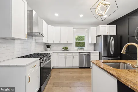 a kitchen with stainless steel appliances granite countertop a sink and cabinets
