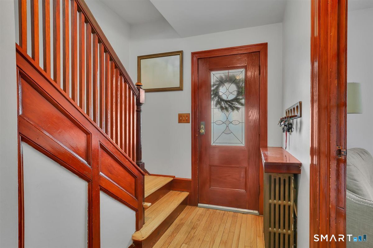 236 Cross Street Middletown, CT 06457 - Photo 4 of 39 The wood detail offers so much charm in this home combined with the hardwood floors with inlay pattern.