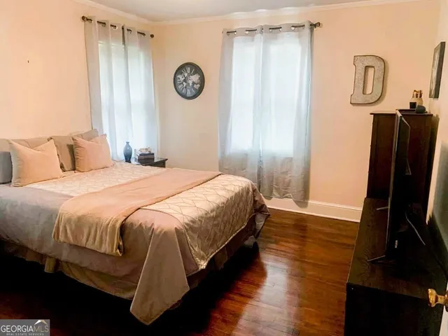 a bedroom with a bed and a mirror