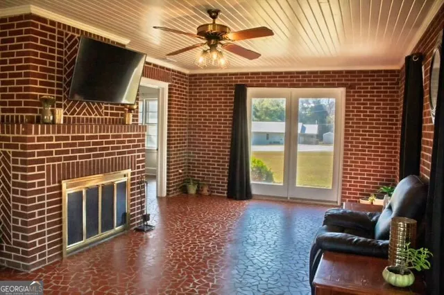 a living room with furniture and a glass door
