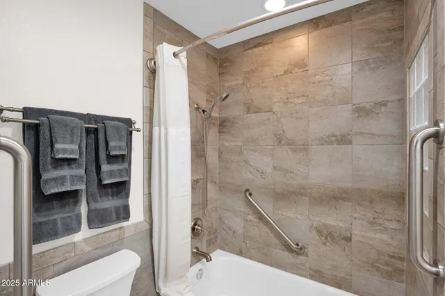 a bathroom with a shower and a toilet