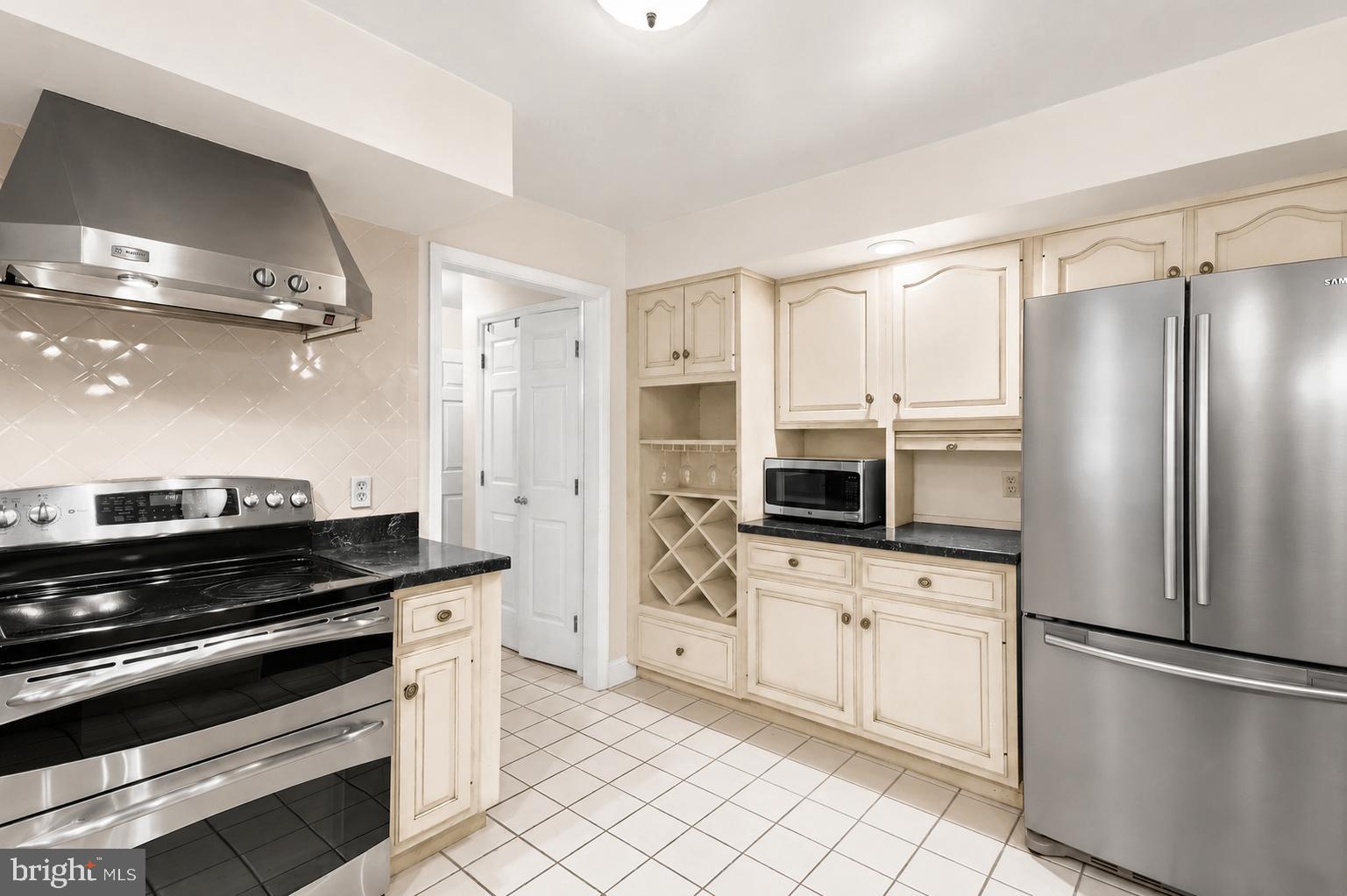 5602 Patterson Road Baldwin, MD 21013 - Photo 54 of 87 Stove, range hood, backsplash, built-in wine rack