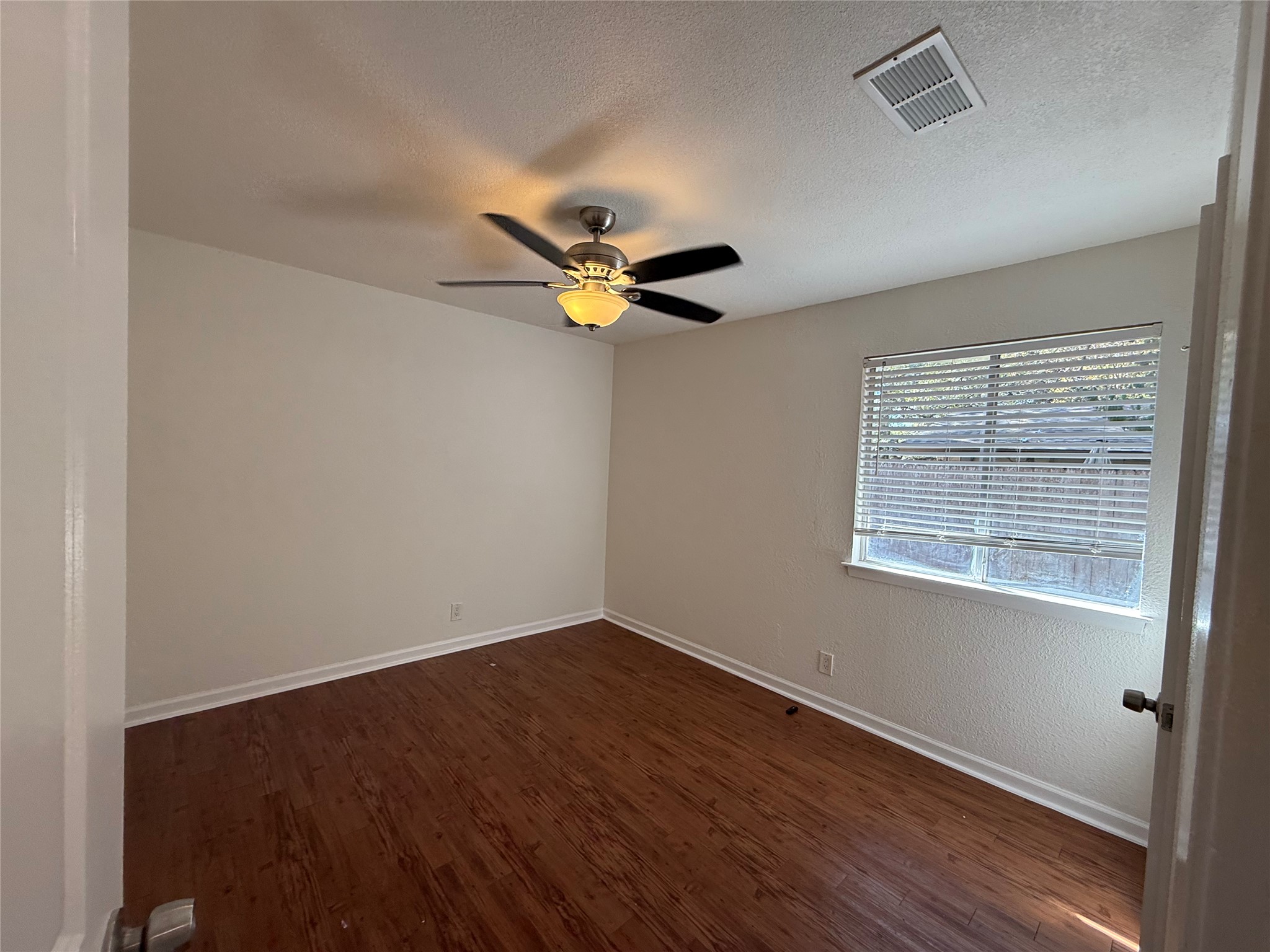 6710 Circle S Road, Unit B Austin, TX 78745 - Photo 9 of 14 a view of wooden floor and a chandelier fan in a room