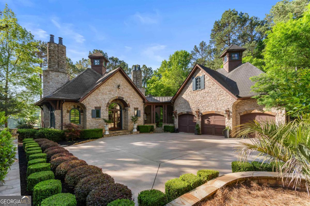 a view of a house with a yard and potted plants