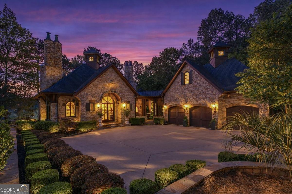 1090 Spring Creek Greensboro, GA 30642 - Photo 2 of 75 a front view of a house with a yard and a garden