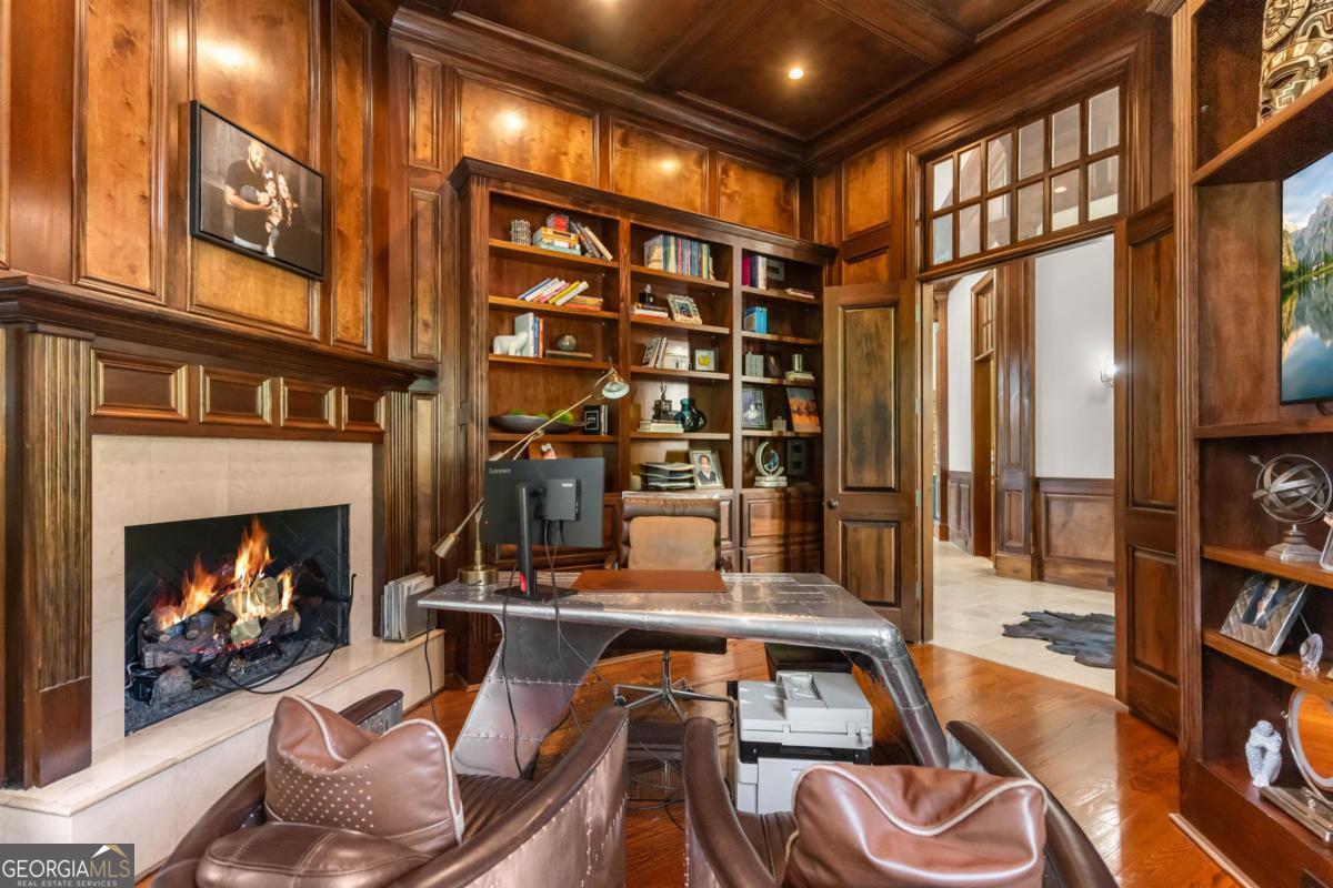 1090 Spring Creek Greensboro, GA 30642 - Photo 21 of 75 a living room with furniture a fireplace and a floor to ceiling window