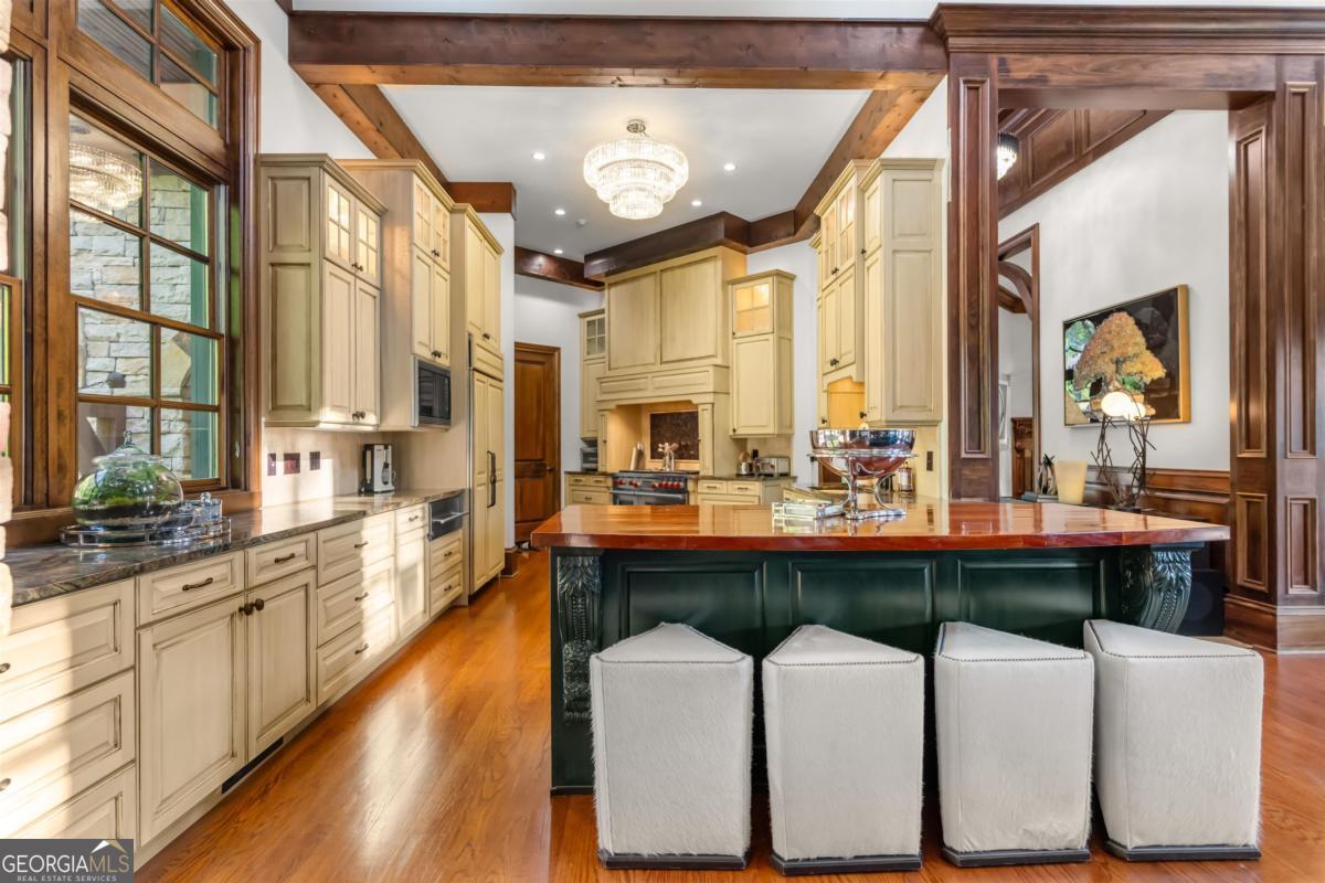 1090 Spring Creek Greensboro, GA 30642 - Photo 28 of 75 a large kitchen with a table and chairs